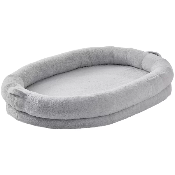 Human dog bed with plush faux rabbit fur cover and supportive orthopedic foam cushion