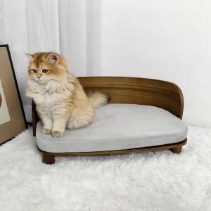 Side view of a wooden elevated cat bed with a grey cushion