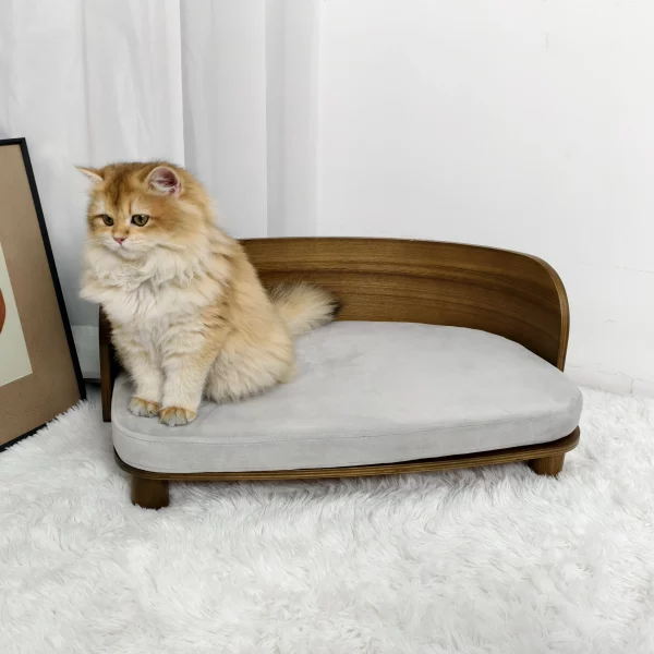 Side view of a wooden elevated cat bed with a grey cushion