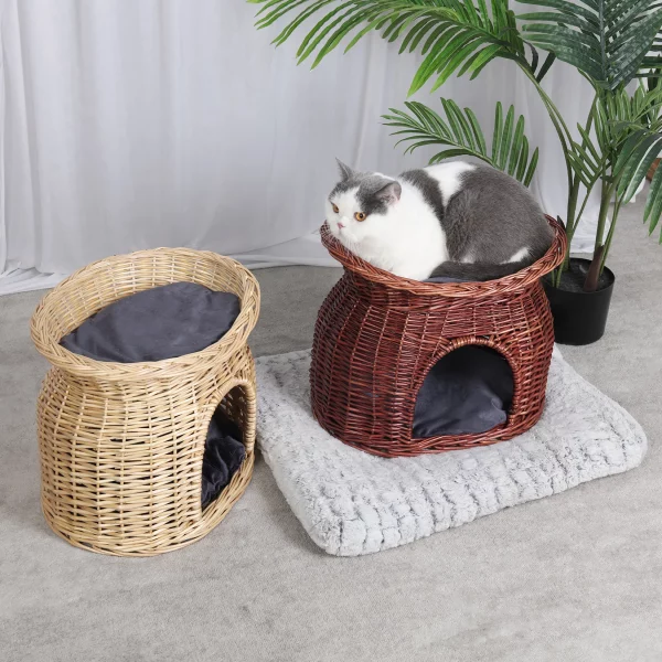 Two cats relaxing in double-tier wicker cat bed