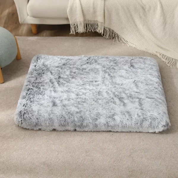 Dog sleeping soundly in a cosy grey pet dog bed