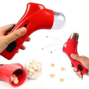 Dog using interactive treat dispenser toy outdoors