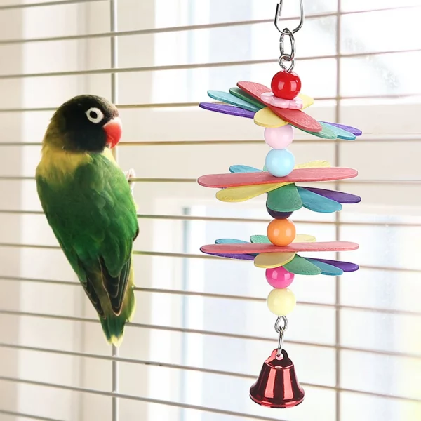 Bird interacting with the colourful cage swing toy