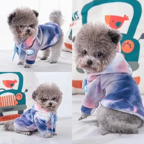 Dog in a relaxed pose wearing a purple tie-dye fleece pet hoodie