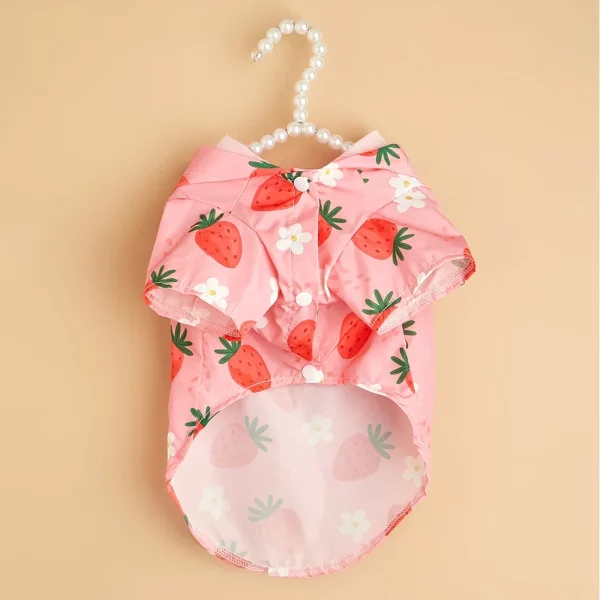 Back view of the pink strawberry dog raincoat, highlighting the hood and leash opening.