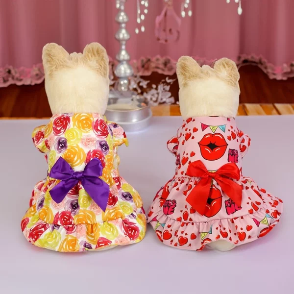 Small dog in a pink patterned dog dress, side profile showing skirt detail