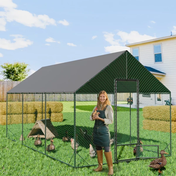 Large walk-in metal chicken coop with green frame and grey cover, front view