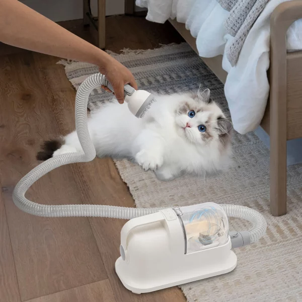 Pet hair grooming tool in use, showing suction capability