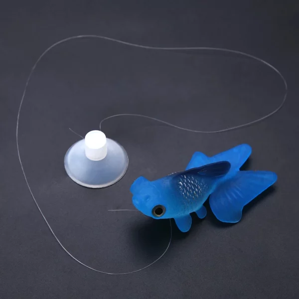 Artificial small fish ornament, placed in a planted aquarium, naturalistic setting