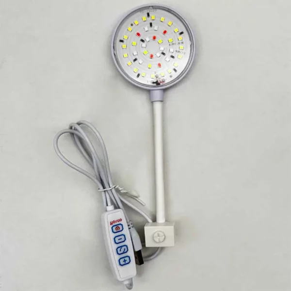 USB clip on aquarium light attached to a small fish tank, showing the light illuminating the water.