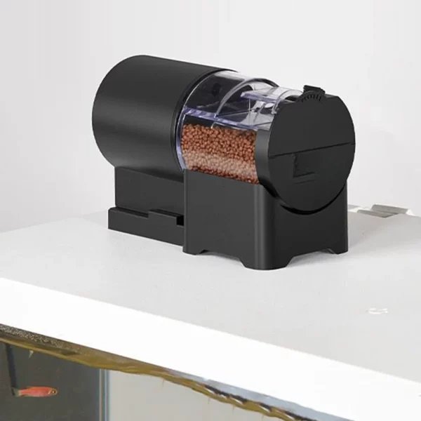Automatic fish feeder mounted securely on an aquarium lid
