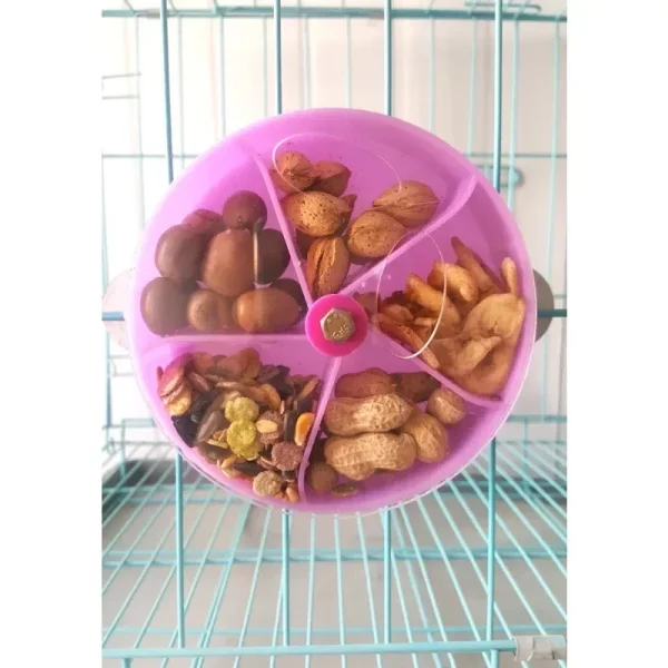 Parrot interacting with the rotating foraging toy inside a cage