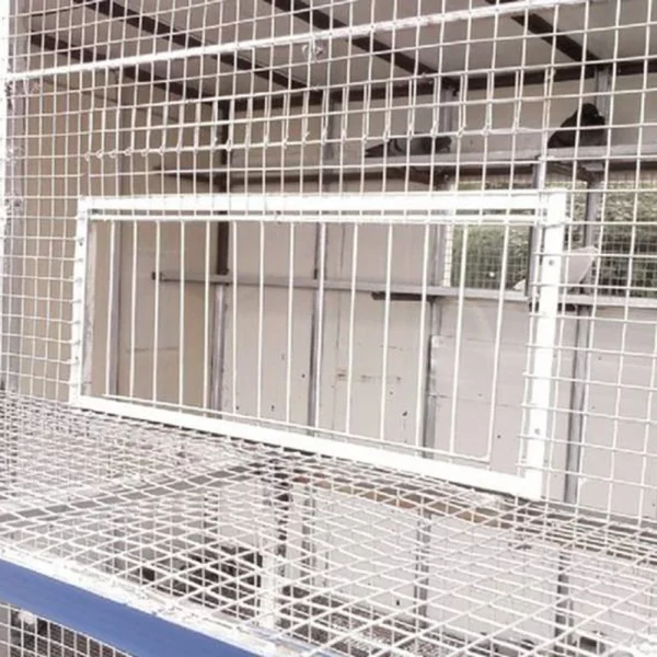Stainless steel pigeon loft door installed on a bird loft opening