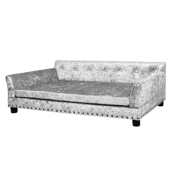 Grey velvet dog bed with wooden legs, angled view