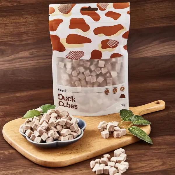 Dog happily eating a freeze-dried duck cube treat
