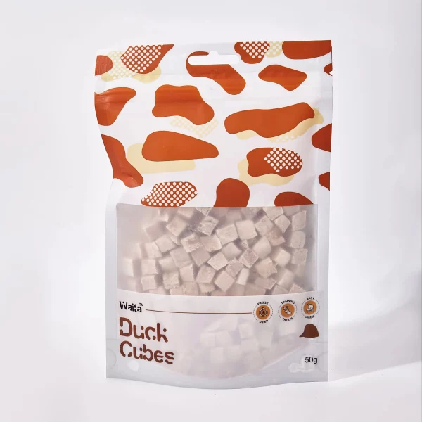 Pet owner holding a bag of freeze-dried duck treats with a dog in the background