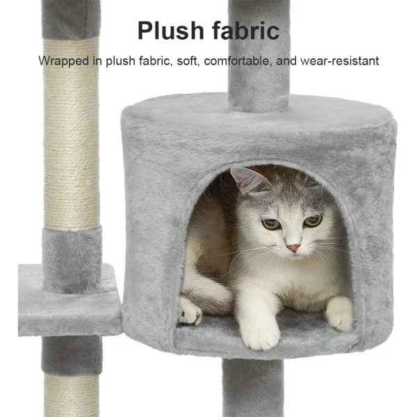 A playful cat interacting with the dangling plush toy attached to the cat tree.