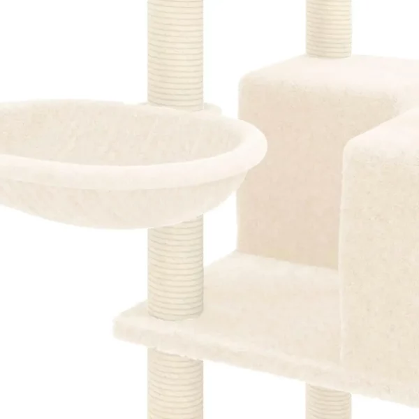 A cat playing on the upper platform of the cream cat tree.