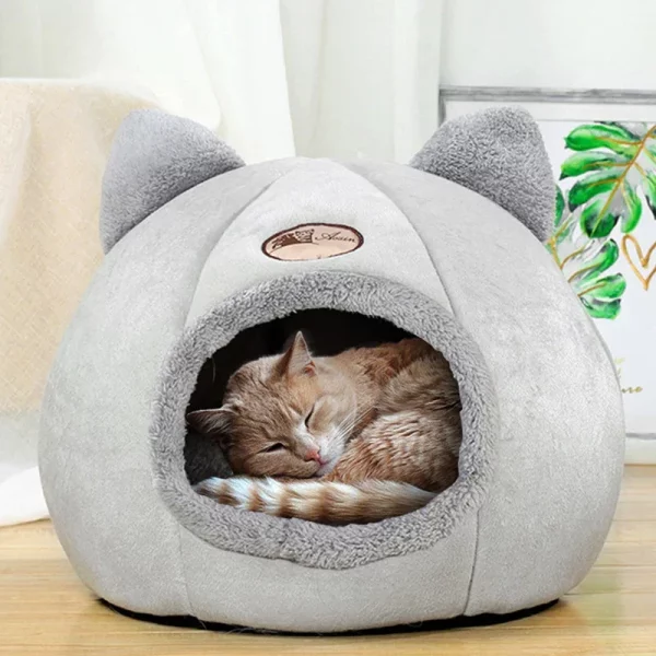 Cat sleeping soundly in the enclosed pet nest
