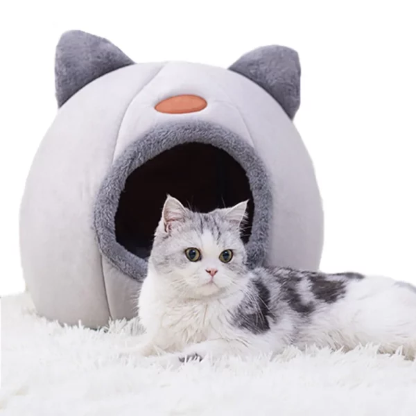 Cat nestled inside warm cave bed, side profile