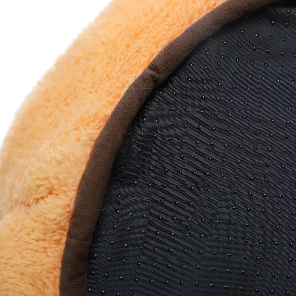 The orange pet bed placed in a home setting
