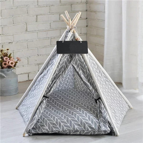 Front view of a pet tent house dog bed with a dog resting inside