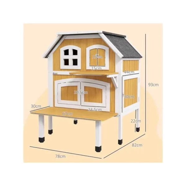 The cat shelter placed outdoors in a garden setting, demonstrating its outdoor use.