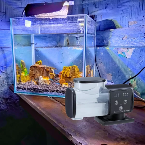 Automatic fish feeder installed on an aquarium rim