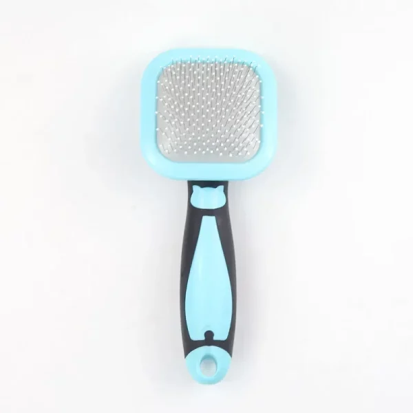 Pet grooming brush in use, showing fur collection on the bristles.